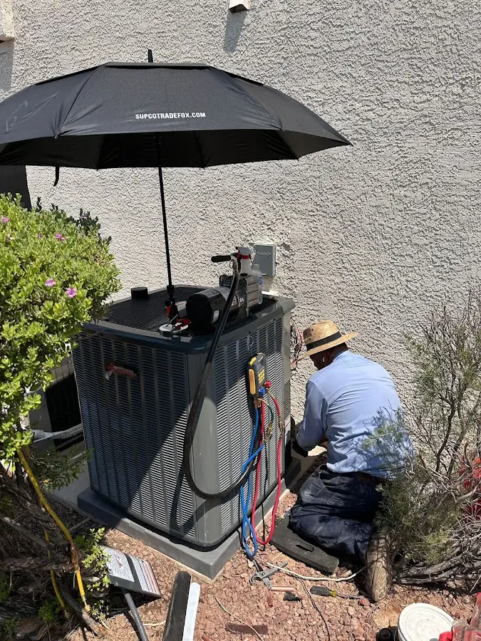 HVAC technician performing outdoor AC maintenance in Billings